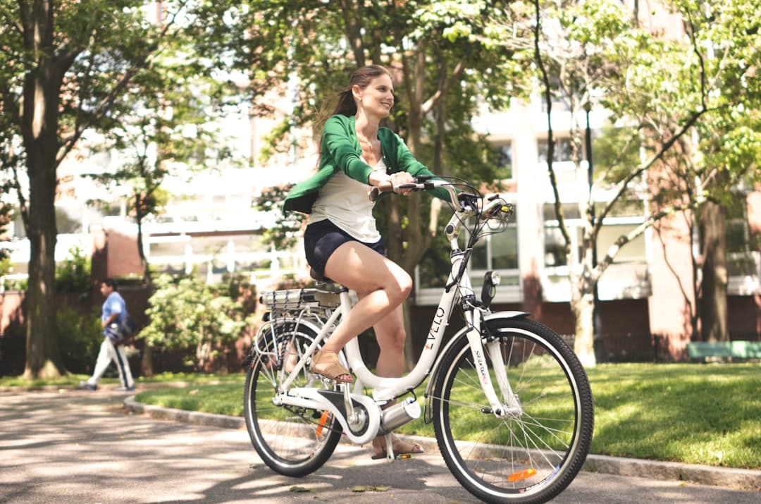 a woman riding a bike down a street